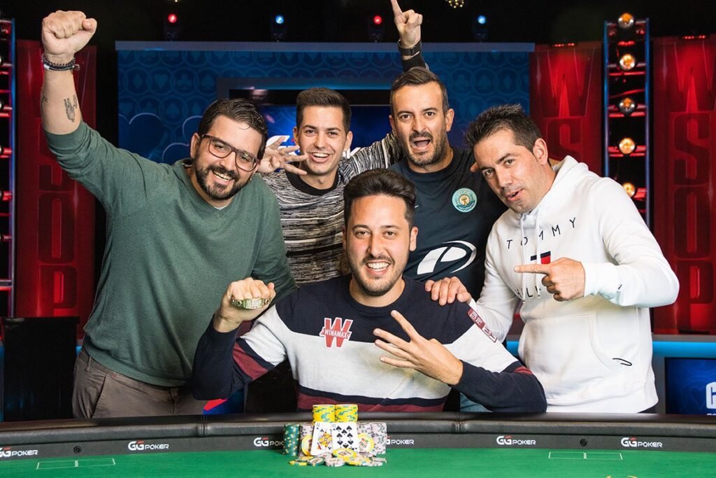 Spanish professional poker player Adrian Mateos posing with friends after winning his fourth career World Series of Poker bracelet.