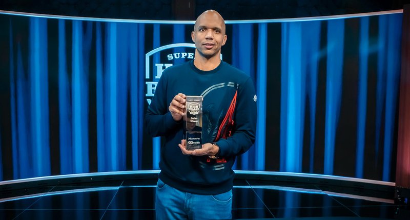 Popular poker player Phil Ivey posing with his Super High Roller bowl Europe Poker Player of the Series trophy.